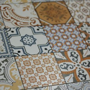 Vibrantly patterned vintage ceramic tiles forming a geometric design.