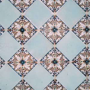 A detailed view of elegant blue and white geometric tiles creating a classic pattern.